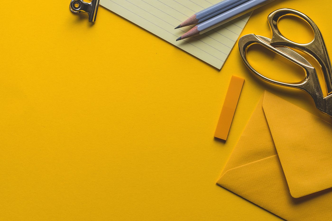 Yellow desk with scissors and pencils